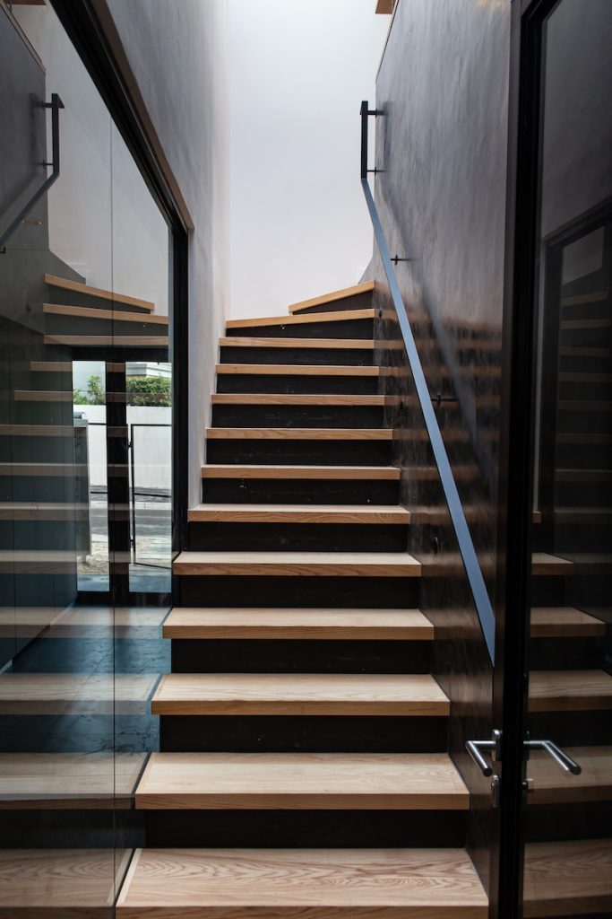 a wooden staircase with glass doors